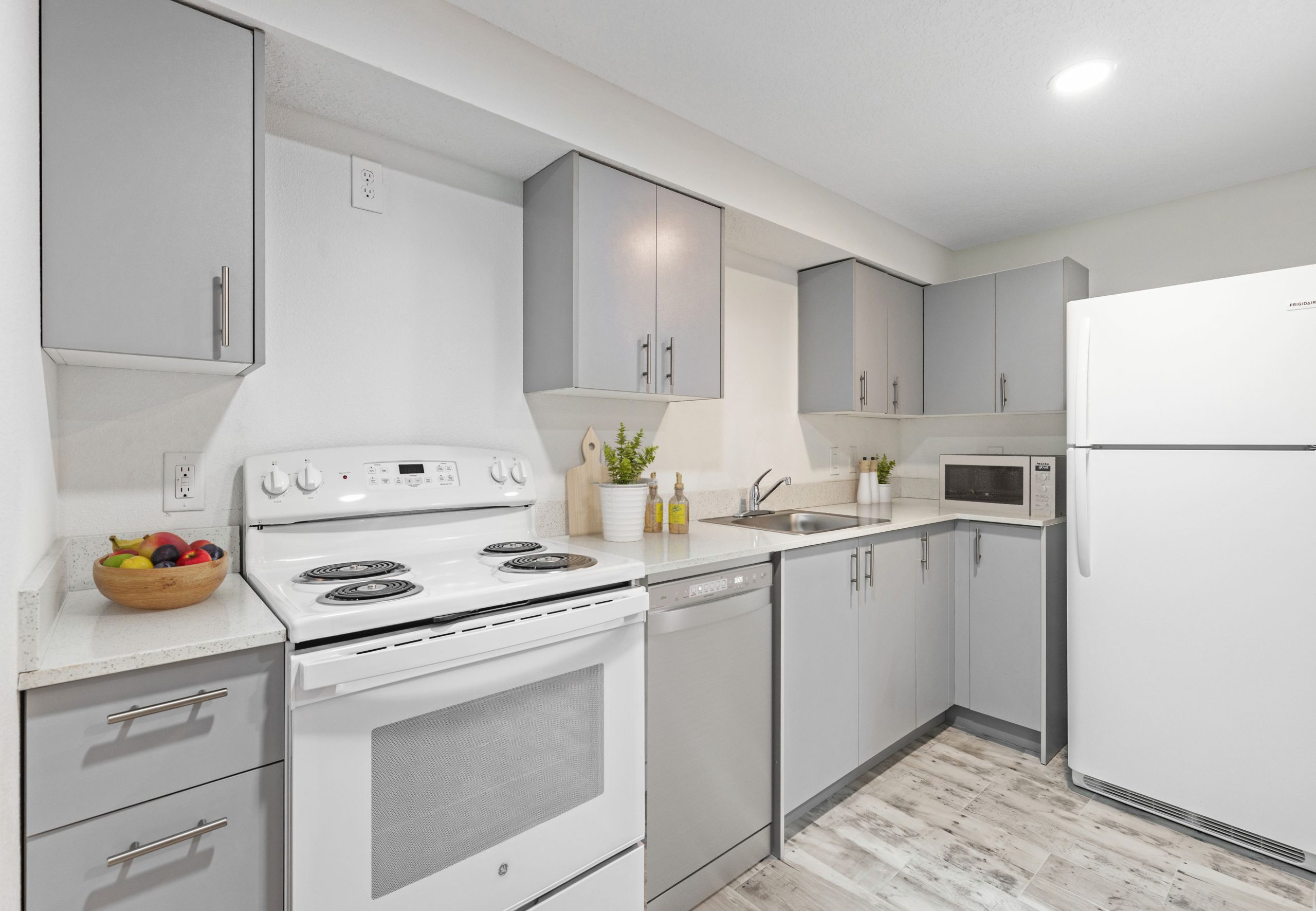 kitchen with cabinets and stove top and fridge