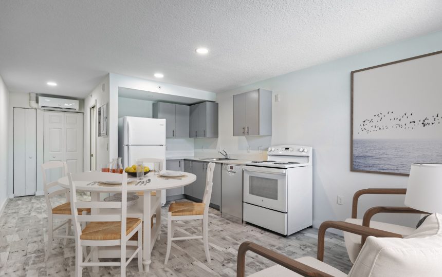Full view of kitchen with chairs and table