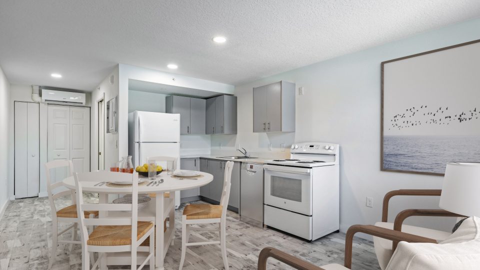 Full view of kitchen with chairs and table